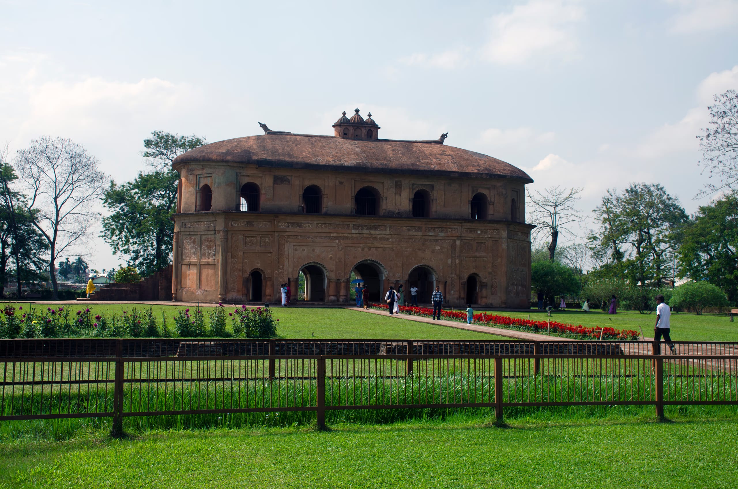The oval two-storeyed Rang Ghar royal pavilion near Sibsagar, with arched ground floor and carved roof finials