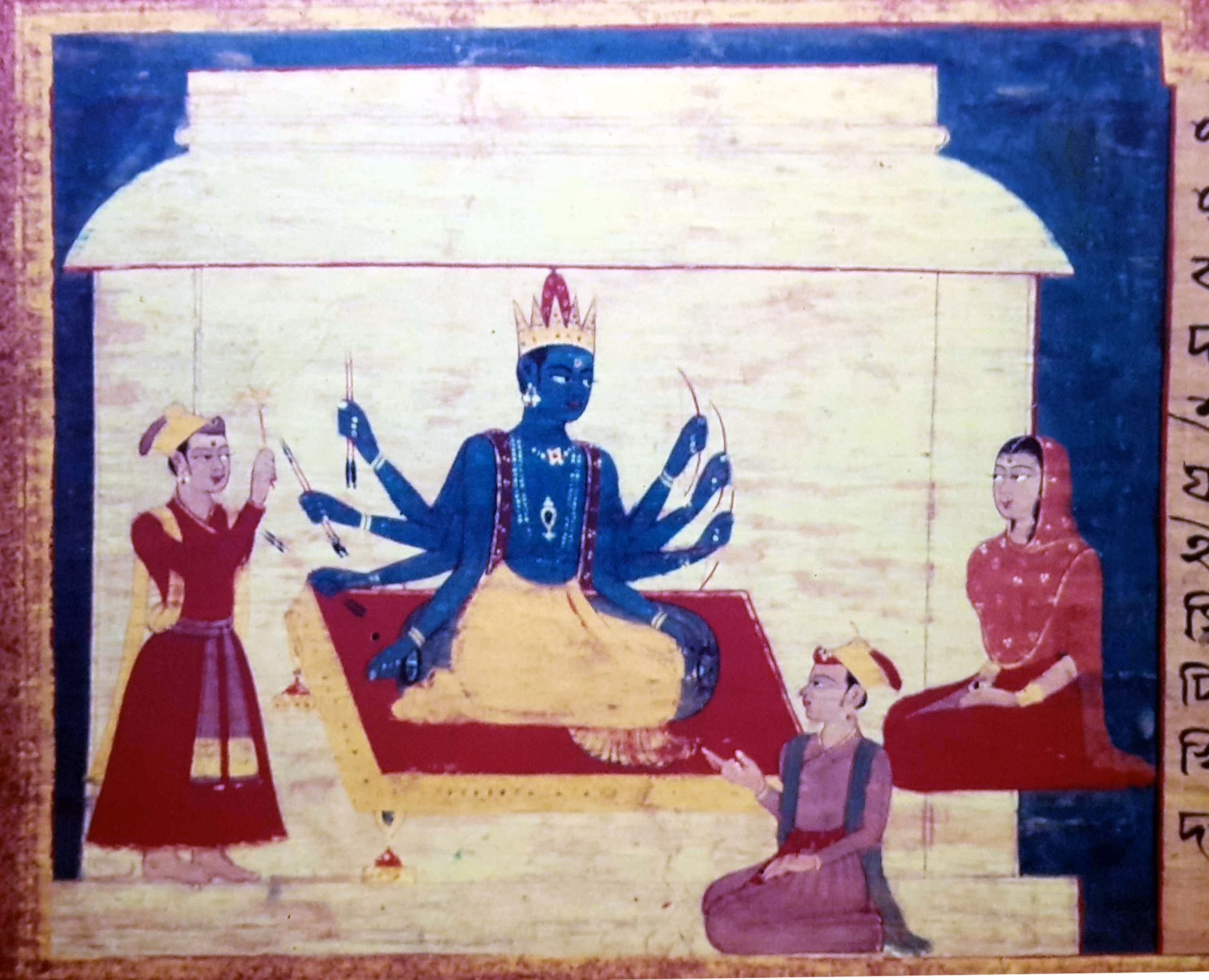 An Assamese manuscript painting: a blue, many-armed crowned deity seated on a red dais under a pavilion, an attendant offering at left and a seated woman at right, a column of old Assamese script running down the right edge